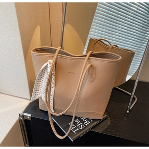 Close-up of beige lychee texture tote bag with WWTU logo and decorative silk scarf