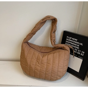 Detail of quilted coffee tote bag featuring adjustable drawstring strap and metal eyelets