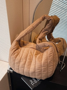 Chic quilted puffer tote bag in camel nylon with a cozy cloud-like texture and wide strap