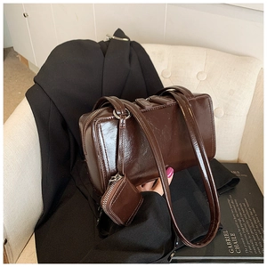 Detail of vintage dark brown faux leather pillow bag with small matching coin purse