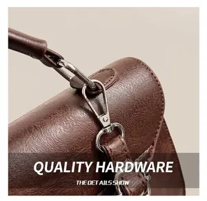 Detailed macro view of the premium silver metal hook and leather texture of a retro backpack