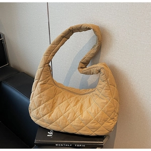 Detailed view of the quilted diamond texture on a stylish ginger brown hobo shoulder bag