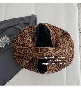Top view of leopard print puffer tote showing internal compartments and zipper pocket