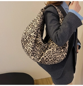 Detailed view of oversized leopard print hobo bag worn with professional office attire