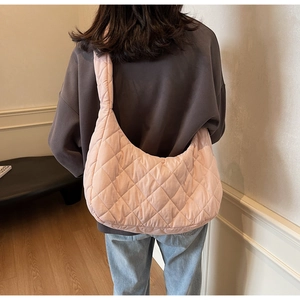 Detailed back view of a pink quilted shoulder bag featuring soft diamond stitching design