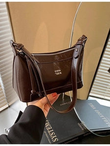 Minimalist dark brown glossy shoulder bag with silver zipper and golden logo