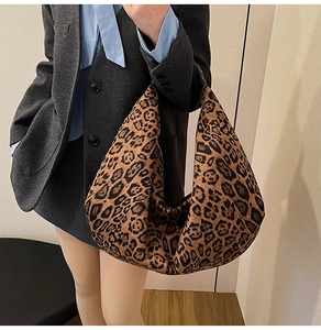 Detailed view of oversized leopard print hobo bag worn with a casual blazer outfit