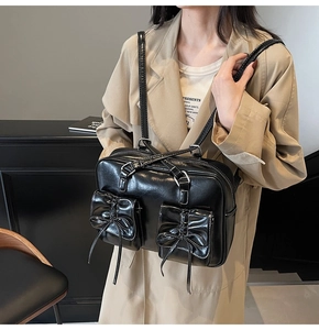 Close-up of black PU leather tote bag with dual bow pockets and versatile shoulder straps