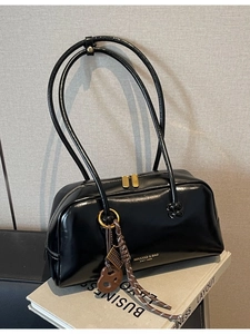 Retro black glossy bowling shoulder bag with gold hardware and heart charm detail