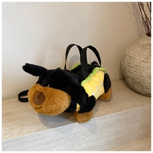 Detailed close-up of a plush black puppy cross-body bag with yellow outfit texture