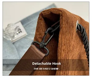 Close-up of detachable swivel hook and corduroy texture on retro brown tote bag