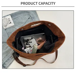 Interior view showing the large capacity of the brown corduroy tote bag with items