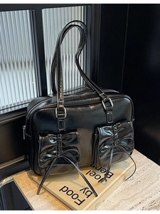 Chic black patent leather tote bag with double bow pockets and contrast stitching detail