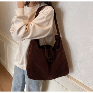 Detail of soft brown suede texture and minimalist design on the large hobo tote bag