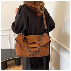 Brown corduroy tote bag detail showing large capacity design and rope knot decoration