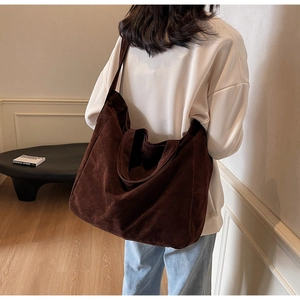 Brown matte suede tote bag shown on a model in a minimalist interior for casual wear