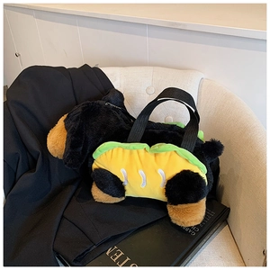 Detail view of a cute dachshund plush handbag on a sofa showing soft fuzzy texture