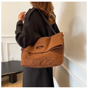 Detail view of brown corduroy tote bag with black woven rope shoulder strap