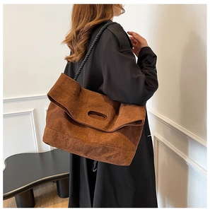 Brown corduroy tote bag detail showing thick ribbed texture and black rope strap