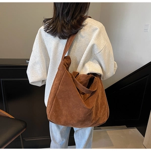 Brown frosted large tote bag shown on model highlighting the spacious design and shoulder strap