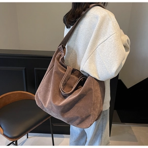 Detail of vintage matte suede tote bag in dark brown showing soft texture and shoulder strap