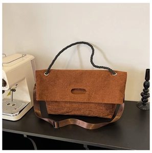 Detail of vintage brown corduroy tote bag featuring unique oval cutout and black rope handle