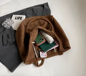 Detail of plush tote bag interior showing large capacity and internal zipper pocket