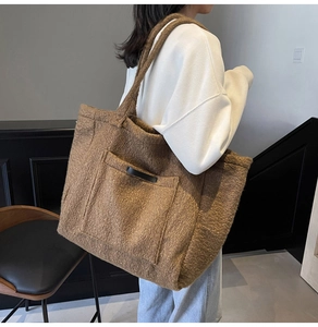Close-up of caramel plush tote bag with large front pocket and faux fur texture