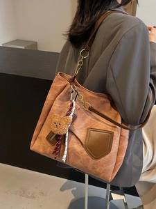 Contrast color vintage brown tote bag with bear charm and chain shoulder strap