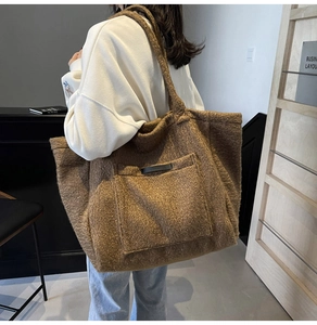 Detailed view of a brown plush tote bag showing soft fleece texture and front pocket
