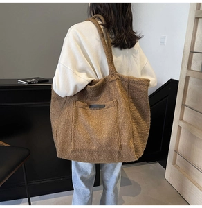 Detailed view of the large brown plush tote bag with a soft fuzzy texture and pocket