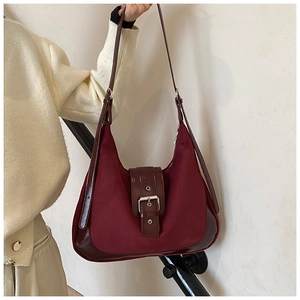 Detail of vintage burgundy tote bag with matte suede texture and silver square buckle