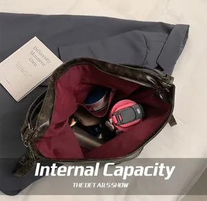 Interior view of large dark brown tote bag showing main compartment and zippered inner pocket