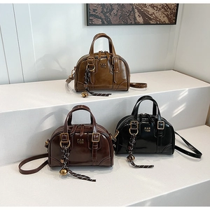Boston style glossy tote bags with gold bell charms in brown, tan and black