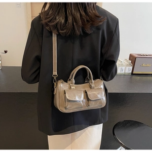 Detail showing vintage small pillow bag with dual front flap pockets and leather texture