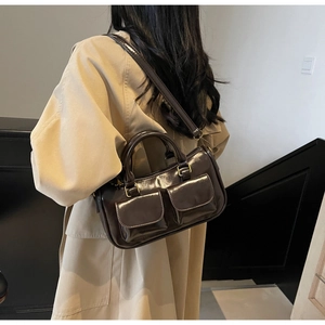 Retro dark brown patent leather crossbody bag with dual front pockets and gold hardware