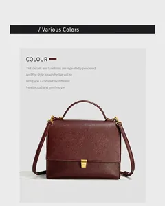 Detailed macro view of dark red lychee leather texture and golden square metal lock