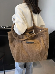 Brown fleece tote bag for women with large capacity and soft fuzzy texture on a model