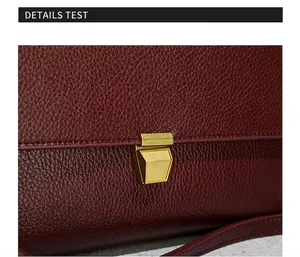 Macro shot of burgundy lychee grain leather texture with gold rectangular metal lock