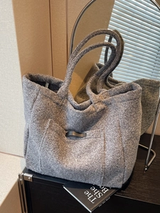 Chic grey faux shearling tote bag with leather accent and front pocket for autumn