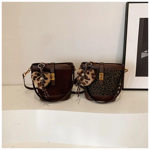 Close-up of retro bucket bags with leopard print heart pendant and gold hardware