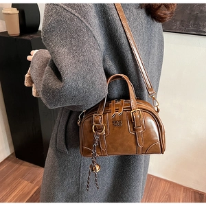 Detail of vintage brown bowling bag featuring PAN TOR embossed logo and adjustable strap