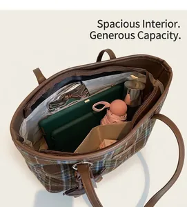 Detail view of large plaid tote bag interior with multi-compartment storage space