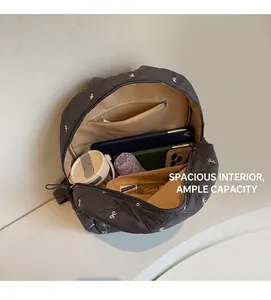Detail of spacious interior in quilted backpack with embroidery and pocket organizer
