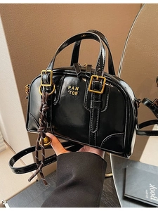 Retro black leather Boston handbag with gold logo and shoulder strap for women