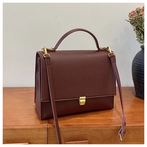 Deep burgundy lychee leather shoulder bag featuring a vintage gold square lock closure
