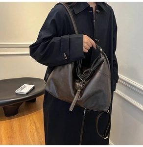 Model wearing dark brown vintage leather tote bag with adjustable shoulder strap details