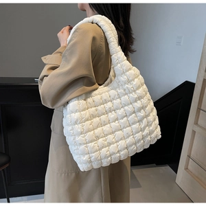 Quilted puffer tote bag detail showing large capacity and white grid texture on shoulder
