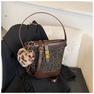 Detail of vintage leopard print bucket bag with gold hardware and plush heart charm