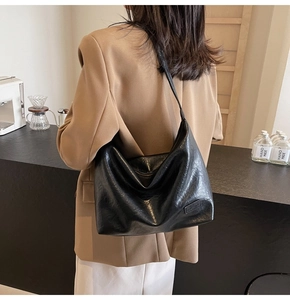 Dettaglio della borsa tote nera in ecopelle con etichetta Hand Made e cerniera